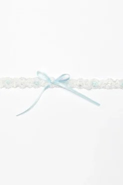 Strumpfband mit blauer Schleife und kleinem Strass-Stein